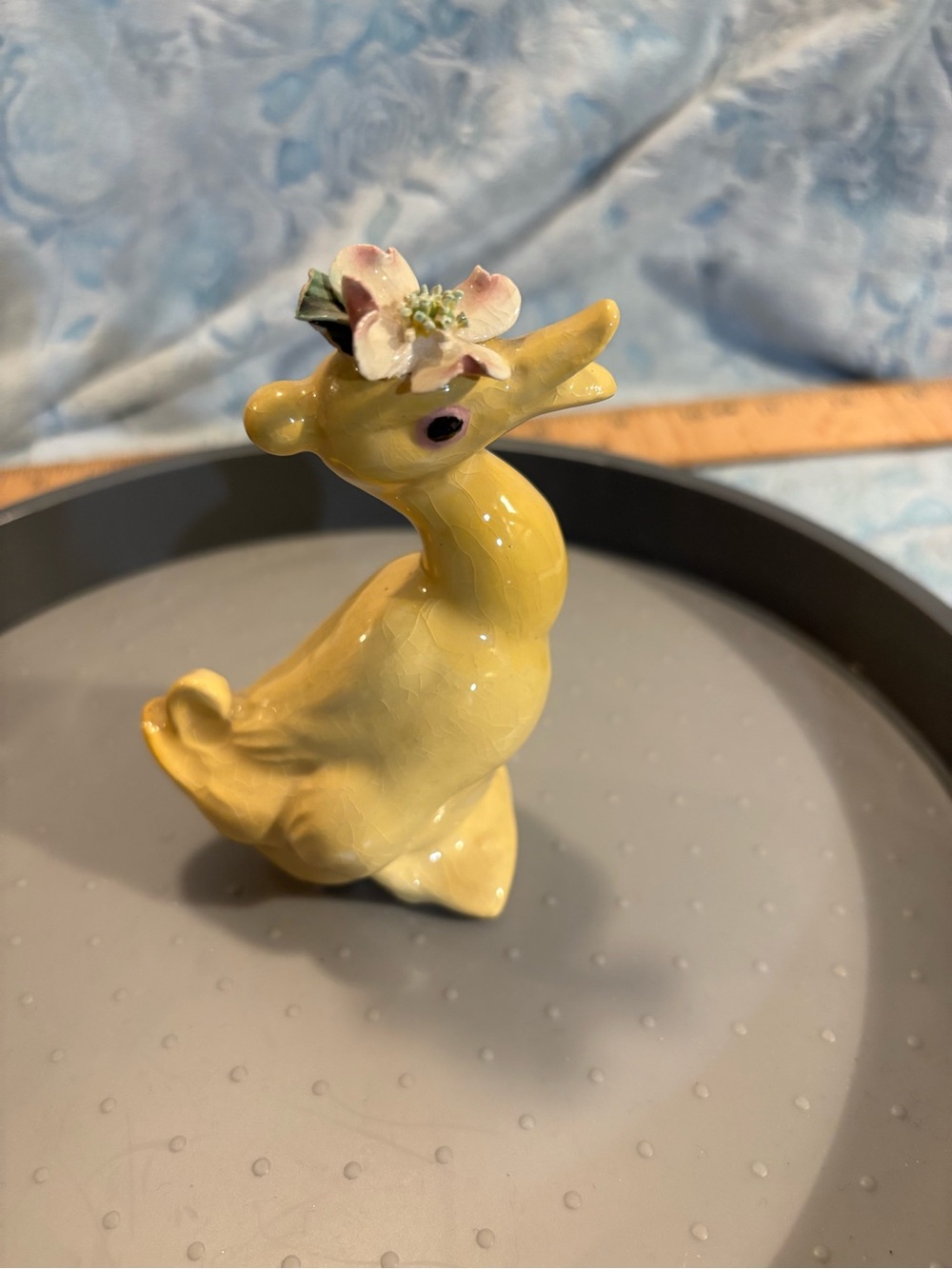 Yellow Ceramic Duck Figurine with Flower Accent